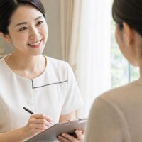 エステでファンの作り方を実践する笑顔のエステティシャンと、お客様への丁寧な接客
